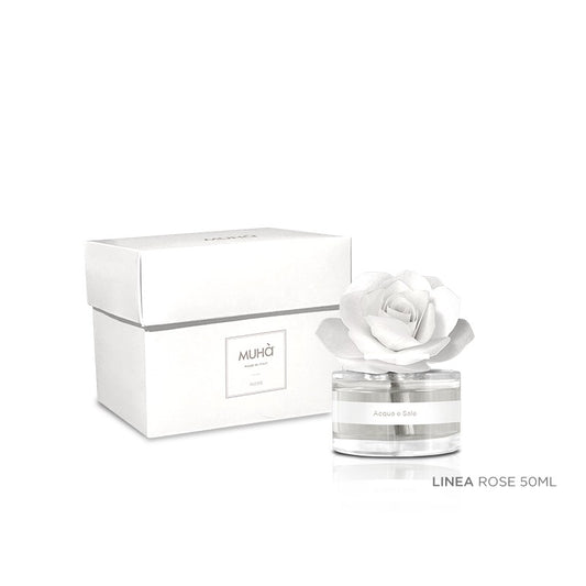 Profumatore d'ambiente Muhà Rosa Diffuser Acqua e Sale in boccetta di vetro trasparente con essenza cristallina, etichetta bianca e diffusore artigianale a forma di rosa in legno bianco avorio, Tutto Chic.