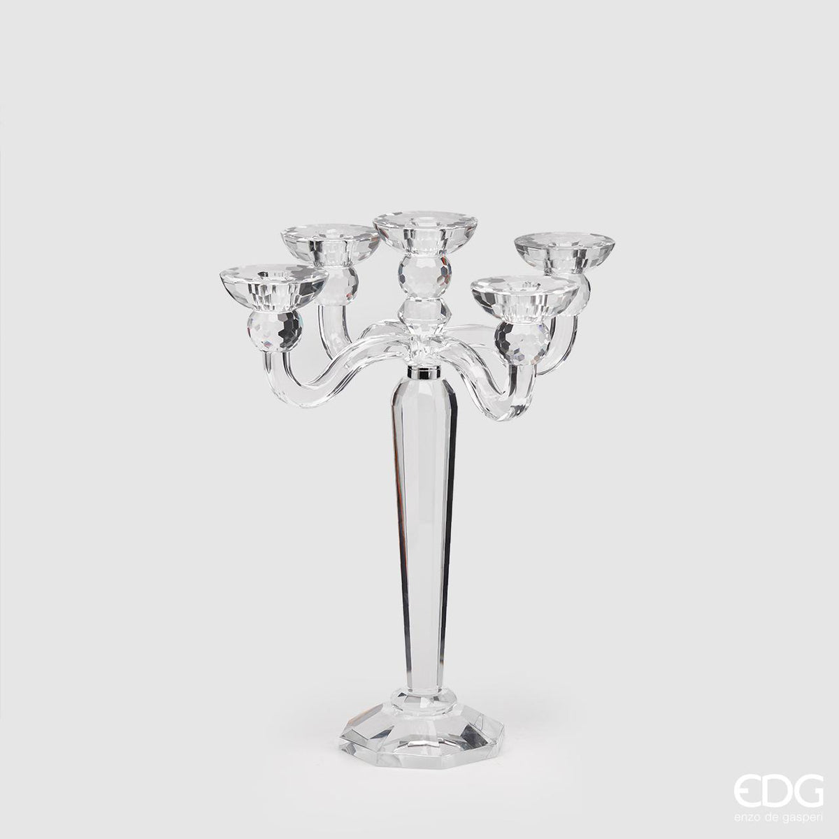 Elegante Candeliere Crystal a cinque fiamme. Realizzato in cristallo di alta qualità, aggiungerà un tocco di luce e lusso alla tua casa. Combina funzionalità e stile per una cena romantica o una serata speciale. Perfetto per regali o per te stesso! Dimensioni: cm 30 Ø x 39 h. In negozio e online su tuttochic.live