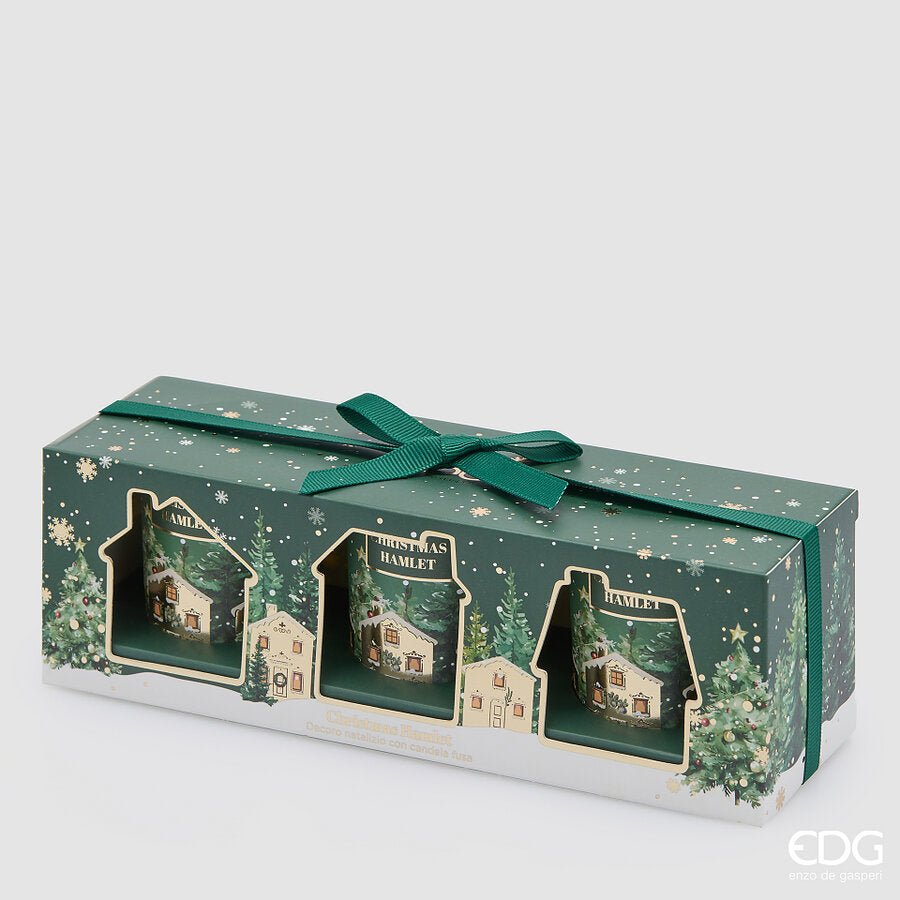 Confezione regalo verde con dettagli oro e bianchi contenente 3 candele natalizie in bicchiere verde con illustrazioni di un villaggio innevato, marchio EDG Enzo De Gasperi.