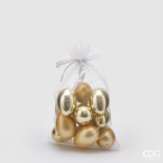 Sacchetto contenente 12 uova in plastica di colore oro, 6 lucide e 6 opache. Dimensioni: h 6 cm. In negozio e online su tuttochic.live