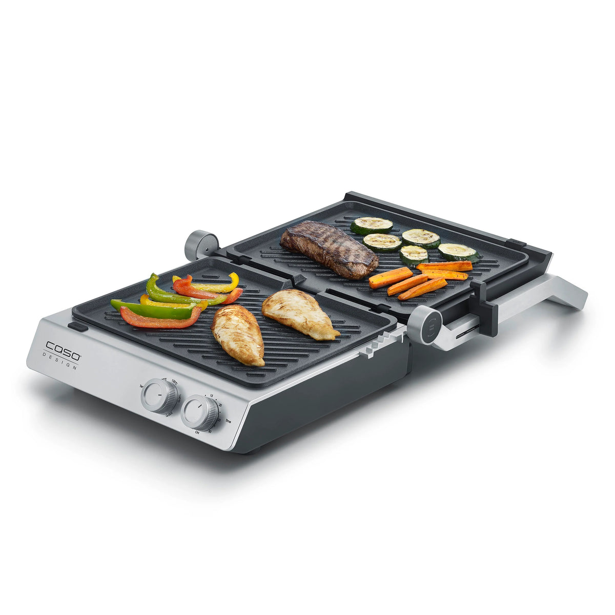 Piastra elettrica SteakChef CASO Design aperta su tavolo da cucina con bistecche in cottura