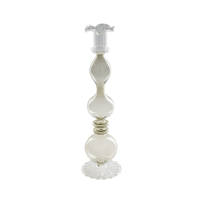 Portacandela "Allacorte". Realizzato in vetro borosilicato con tonalità di colore fumè. Dimensioni: Ø 9 x 32.5 h cm. In negozio e online su tuttochic.live 