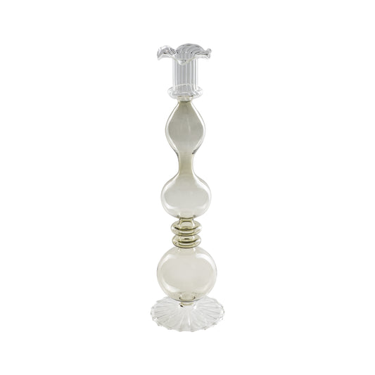 Portacandela "Allacorte". Realizzato in vetro borosilicato con tonalità di colore fumè. Dimensioni: Ø 9 x 32.5 h cm. In negozio e online su tuttochic.live 