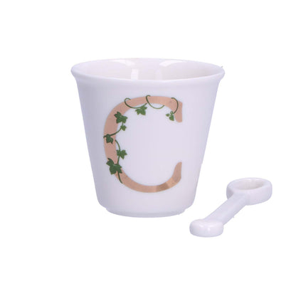 "Unico" Bicchierino in porcellana con iniziale decorata e cucchiaino. Capacità 75 cc Dimensioni: diametro cm 6,7- altezza cm 6 Lavare a mano 