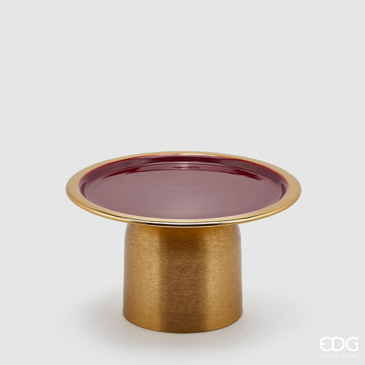 Alzata tonda in metallo color oro con piano smaltato di colore bordò. Dimensioni: cm diametro cm 25, altezza cm 14. In negozio e online su tuttochic.live