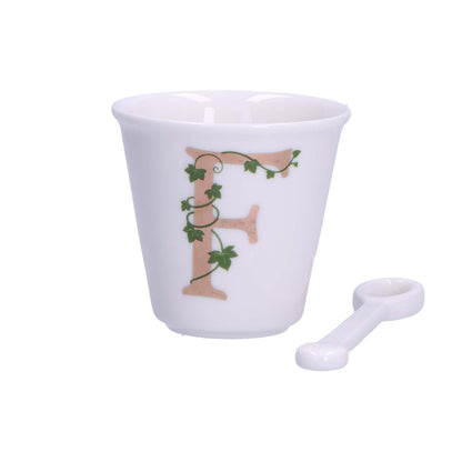 "Unico" Bicchierino in porcellana con iniziale decorata e cucchiaino. Capacità 75 cc Dimensioni: diametro cm 6,7- altezza cm 6 Lavare a mano 