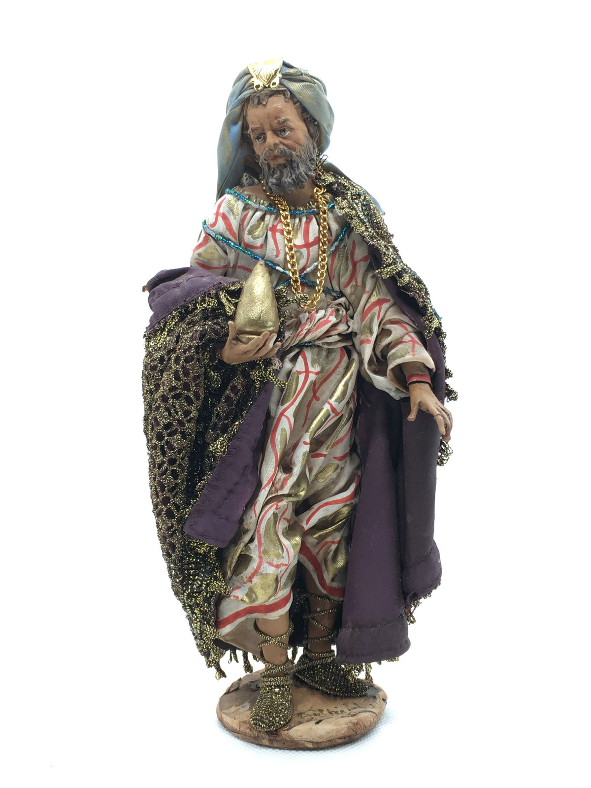 Statuina del Re Magio Baldassarre per presepe di Angela Tripi, alta 20 cm, in terracotta e stoffa con mantello dorato, turbante azzurro e dono in mano.