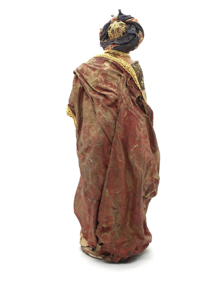 Vista posteriore del ricco mantello drappeggiato rosso e oro e del turbante della statuina del Re Magio Gaspare Angela Tripi.