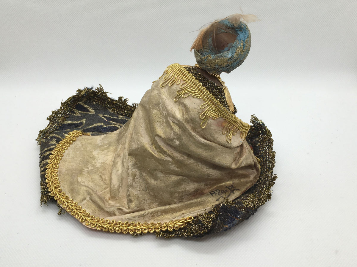 Vista posteriore del mantello beige e oro con frange dorate e firma dell'artista sulla statuina di Melchiorre Angela Tripi.