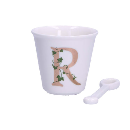 "Unico" Bicchierino in porcellana con iniziale decorata e cucchiaino. Capacità 75 cc Dimensioni: diametro cm 6,7- altezza cm 6 Lavare a mano 