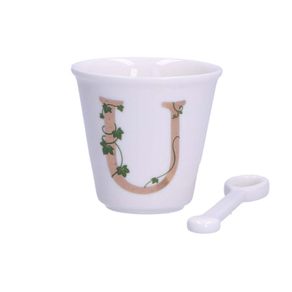 "Unico" Bicchierino in porcellana con iniziale decorata e cucchiaino. Capacità 75 cc Dimensioni: diametro cm 6,7- altezza cm 6 Lavare a mano 