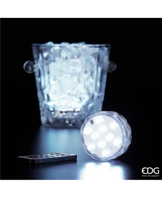 Base con luci a led decorative, può essere collocata in secchielli pieni di ghiaccio perché resiste all'acqua, in vasi portafiori o dovunque la tua creatività vuole collocarla. Funziona con batterie, corredata di telecomando per controllo remoto. Dimensioni: cm ø 7 x 2,5. In negozio e online su tuttochic.live