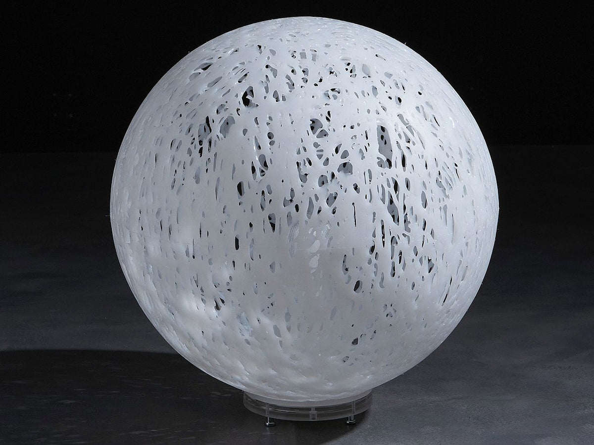 Lampada da terra con paralume in materiale plastico termofuso: una parte deriva dal processo di riciclo. Il paralume sferico è bianco. Predispone un attacco E27, compatibile con lampadina alogena, fluorescente compatta o LED (non inclusa). Dimensioni: cm Ø 48 x h 52. In negozio e online su tuttochic.live